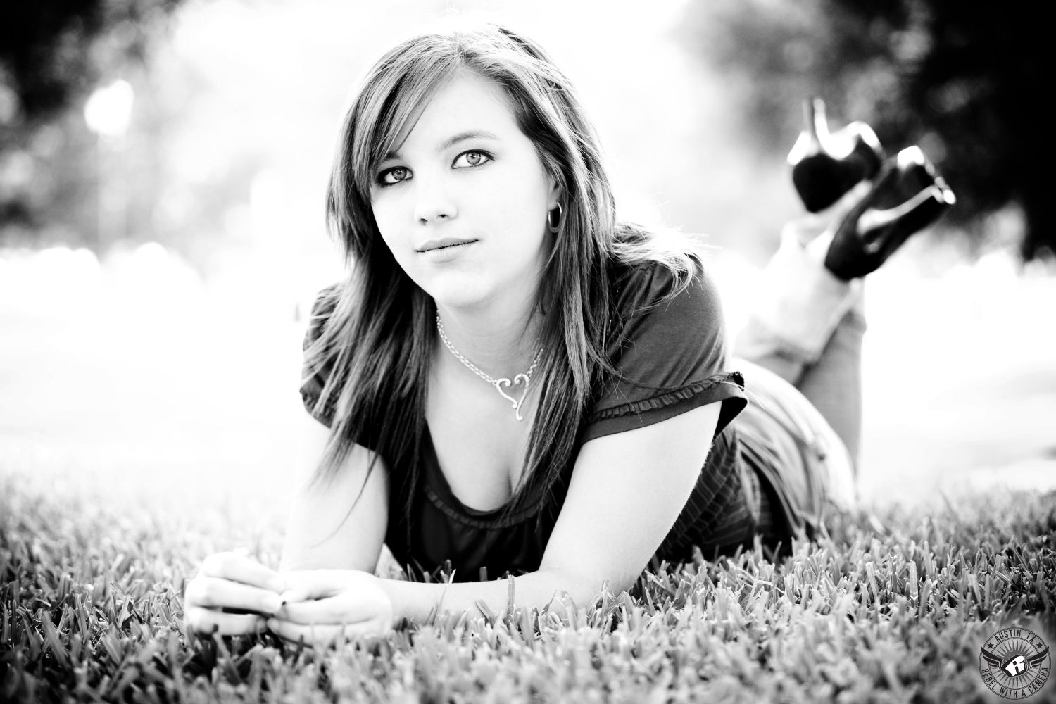Black and white picture of girl on the grass taken at the Texas State Captiol by Austin senior portrait photogapher.